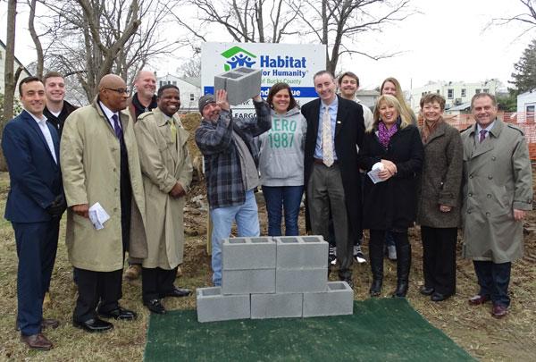 Photo caption: Attending Habitat for Humanity of Bucks County's wall raising in Morrisville were (l to r) Christopher Smylie (Parx Casino), Kevin Long (Toll Brothers), Ron Davis (Parx Casino), Ken Hill (Toll Brothers), Stephen Briggs (Wells Fargo), Bill and Tina (homebuyers), Congressman Brian Fitzpatrick, Jarrett and Alyson (family members), Michelle Saldutti (Parx Casino), Florence Kawoczka (Habitat Bucks County), and Todd Hurley (Penn Community Bank).Photo credit: Stefanie Clark